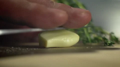 Chef squeezing the juice from the garlic cloves Stock Footage 65337758