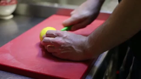 Chef squeezing a lemon in a green juicer Stock Footage 137945782