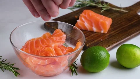 Chef squeezing lime juice on salmon fish fillet for cooking ceviche Stock Footage