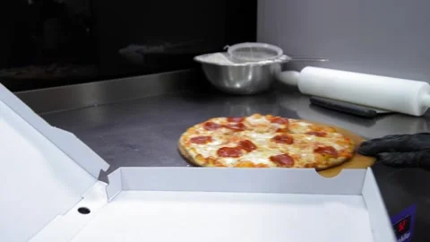 Chef stacking pizza in cardboard box for delivery to customer Stock Footage 267285962