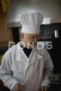 A chef standing in a kitchen Stock Photos