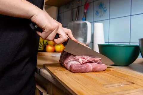 Chef starting to slice big piece of raw meat stock photo Stock Photos