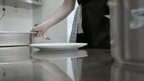 Chef Starts Assembling / Plating A Dish On A Inox Kitchen Counter Stock Footage 95151711
