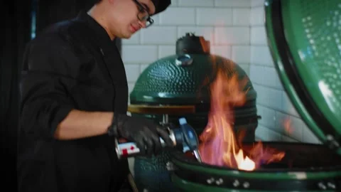 The chef starts a fire on the grill Stock Footage 131152112