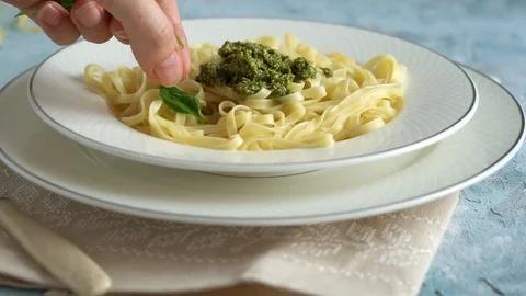 Chef steals a plate of pasta with spinach leaves Stock Footage 119327611