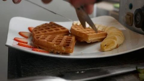 Chef step by step preparing Belgian waffles with bananas, strawberries, ice Stock Footage 122282647