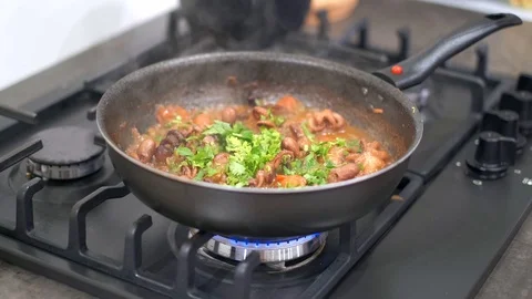 Chef stir fried vegetables and baby octopus in a Stock Footage 113010699
