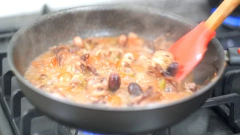 Chef stir fried vegetables and baby octopus in a Video stock 113010953