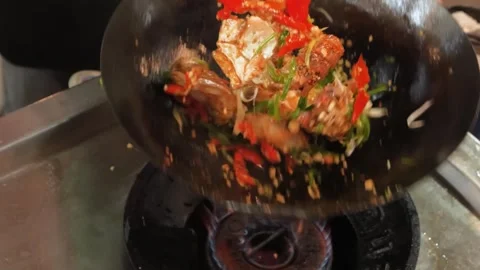 Chef Stir-Frying Fresh Seafood and Vegetables in a Smoking Hot Wok 動画素材 344223589