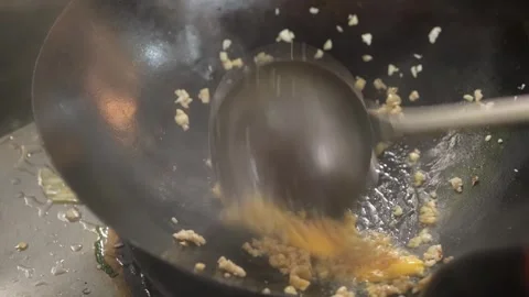 Chef Stir-Frying Minced Garlic and Aromatics in Wok Stock Footage 344230407