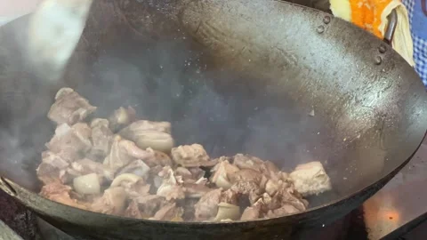 A chef is stir-frying mutton in a wok Stock Footage 254147445