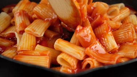 Chef stir pasta with boiling tomato sauce, close up Stock Footage 246742049