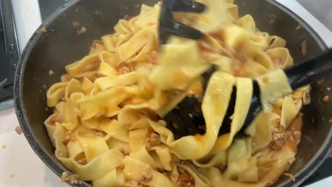 Chef stir pasta with boiling tomato sauce. Cooking traditional Italian dinner Stock Footage 265683093