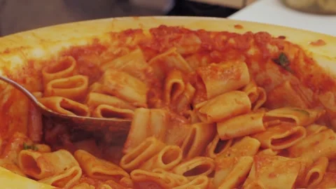 Chef stir pasta with boiling tomato sauce in cheese wheel on street, close up Stock Footage 284865375