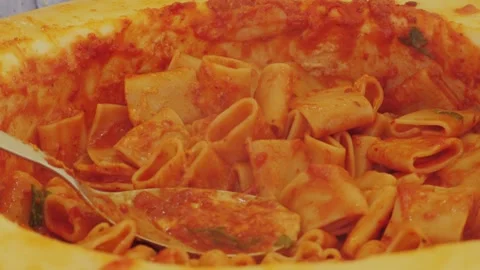 Chef stir pasta with boiling tomato sauce in cheese wheel on street, close up Stock Footage 289663564