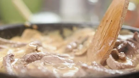 Chef stirring beef stroganoff in a frying pan. Stock Footage 152518540