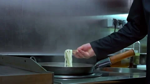 Chef Stirring Boiling Noodles With Chop Sticks in A Pan. Stock Footage 159508604