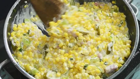 The chef is stirring the cheesy corn casserole in the pan. Stock Footage 210717505