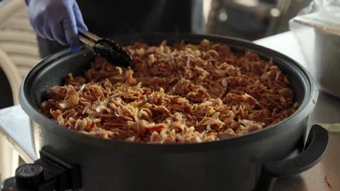Chef stirring a large pot of hot, steaming kebab or pulled pork meat Stock Footage 314288119
