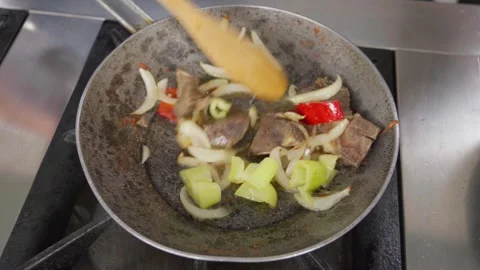Chef stirring meat and vegetables in pan Stock-Footage 286309812