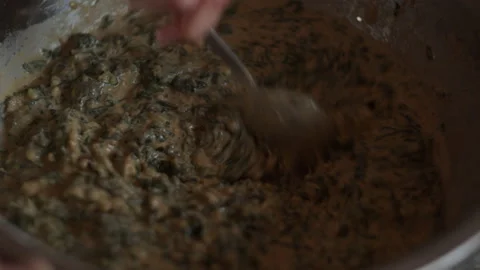 Chef stirring with a spoon flour herbs greens in bowl. Cook vegan healthy food Stock Footage 154645720