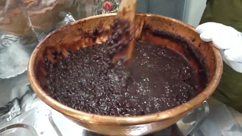 Chef Stirring Sweet Red Bean Paste in a Traditional Copper Pot Close Up Stock Footage 345292352