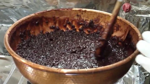Chef Stirring Thick Dark Paste in Copper Pot Close-Up 스톡 동영상 345292399