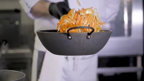 Chef is stirring vegetables in wok Video stock 106275209