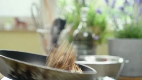The chef stirring walnuts in a frying pan. Stock-Footage 200810622