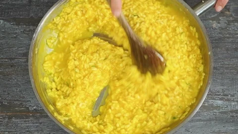 The chef stirs the cooked pumpkin risotto. Stock Footage 207018466