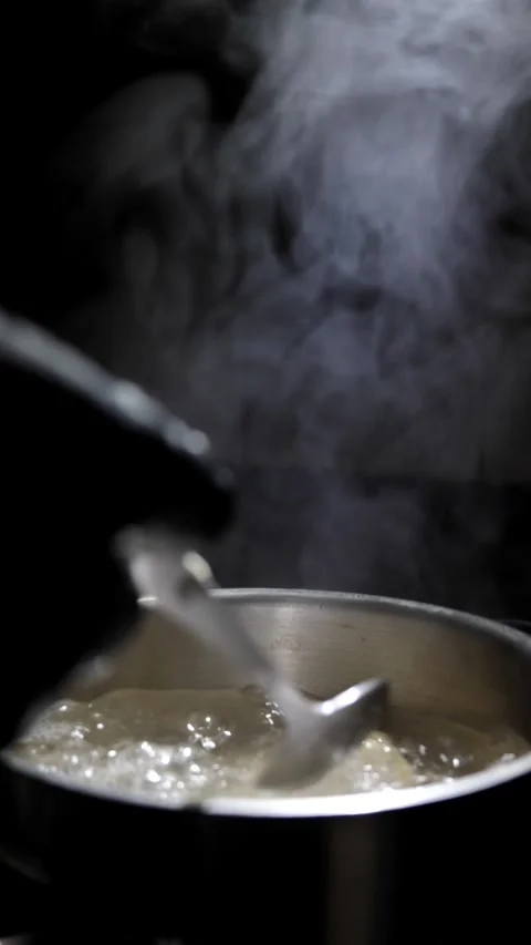 Chef stirs dumplings in boiling water. slow motion, Restaurant menu Stock Footage 309279474