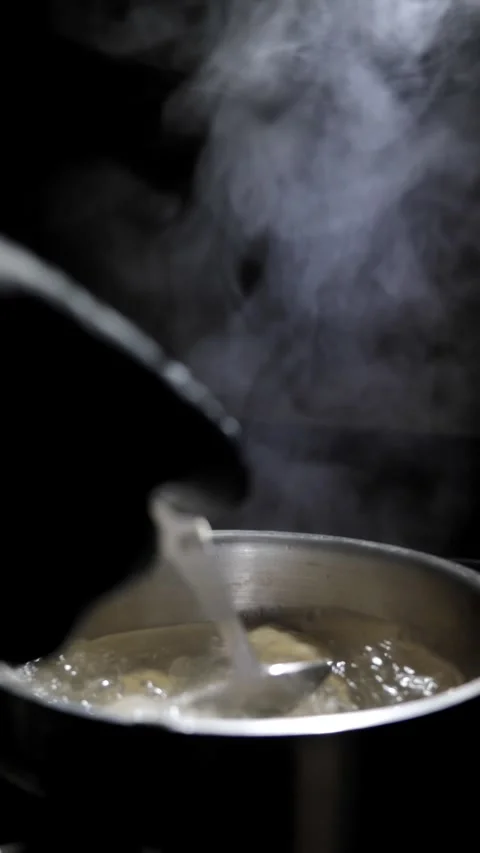 Chef stirs dumplings in boiling water Stock Footage 310340404