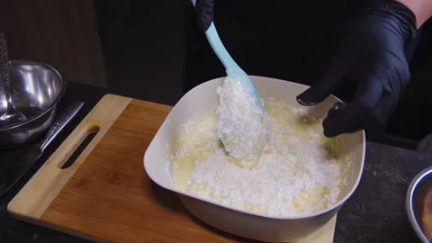 Chef stirs flour with dough in kitchen Stock Footage 307312694