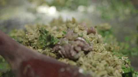 A chef stirs ingredients in a hot pan. A delicious Cafe de Paris sauce is Stock Footage 256057919