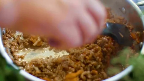 Chef stirs minced meat sauce in a frying pan Stock Footage 333834141