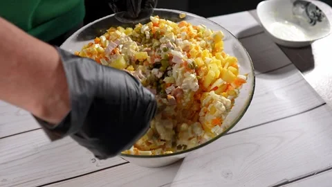 The chef stirs the salad with a spoon. Stock Footage 291685164