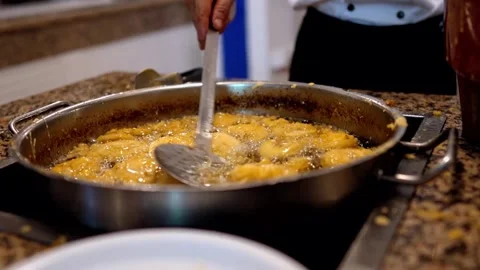 A chef stirs a stew in a clay pot, creating a delicious culinary masterpiece Stockbeeldmateriaal 276420002