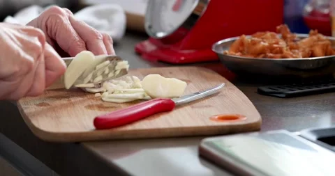 Chef stirs thickened caramelized sauce in saucepan on gas stove. Stock Footage 220759284