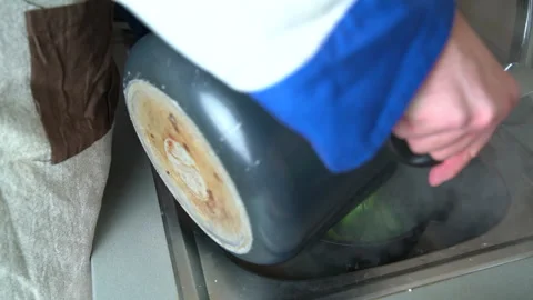 Chef straining broccoli in the kitchen sink Stock Footage 161162492