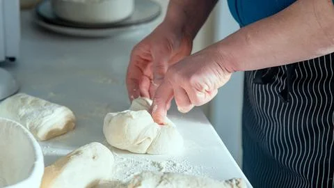 Chef Stretching and folding bread dough. Stock Photos