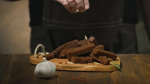Chef strews deep-fried croutons or beer snacks with garlic and seasonings Stock Footage 94669960