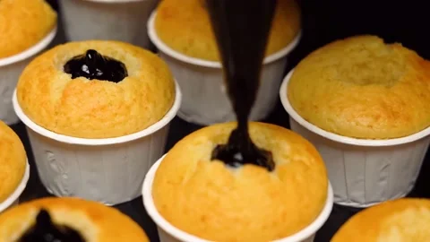 The chef stuffs the muffins with the filling Stock Footage