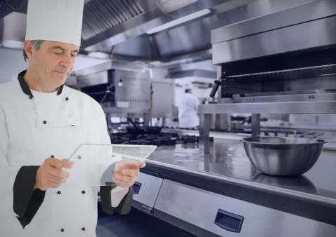 Chef with tablet in kitchen with blue overlay Stock Photos