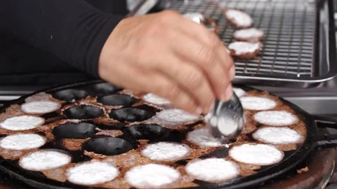 Chef take coconut rice pancake out of the pan Stock Footage 230589059
