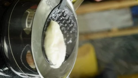 The chef takes a boiled egg out of boiling water in a saucepan. Vertical video. Stock Footage 311046143