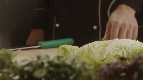 Chef takes his hand off the table leaves chinese cabbage. HD Slow Motion Stock Footage 113550379