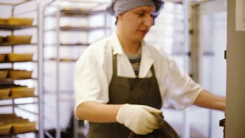 Chef takes hot bread from the oven Stock Footage 69779307