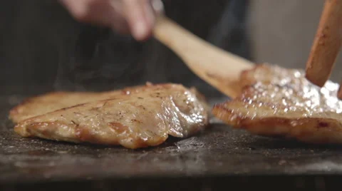 Chef takes off the meat from the pan Stock Footage 67765515