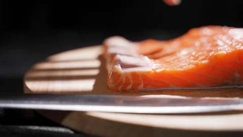 Chef takes out bones from the salmon fillet, cutting fish on slices for cooking Stock Footage 118510662