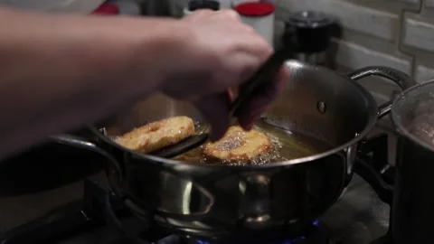 Chef takes out ready-made apples in dough, fried in pan in boiling oil Stock Footage 167578750